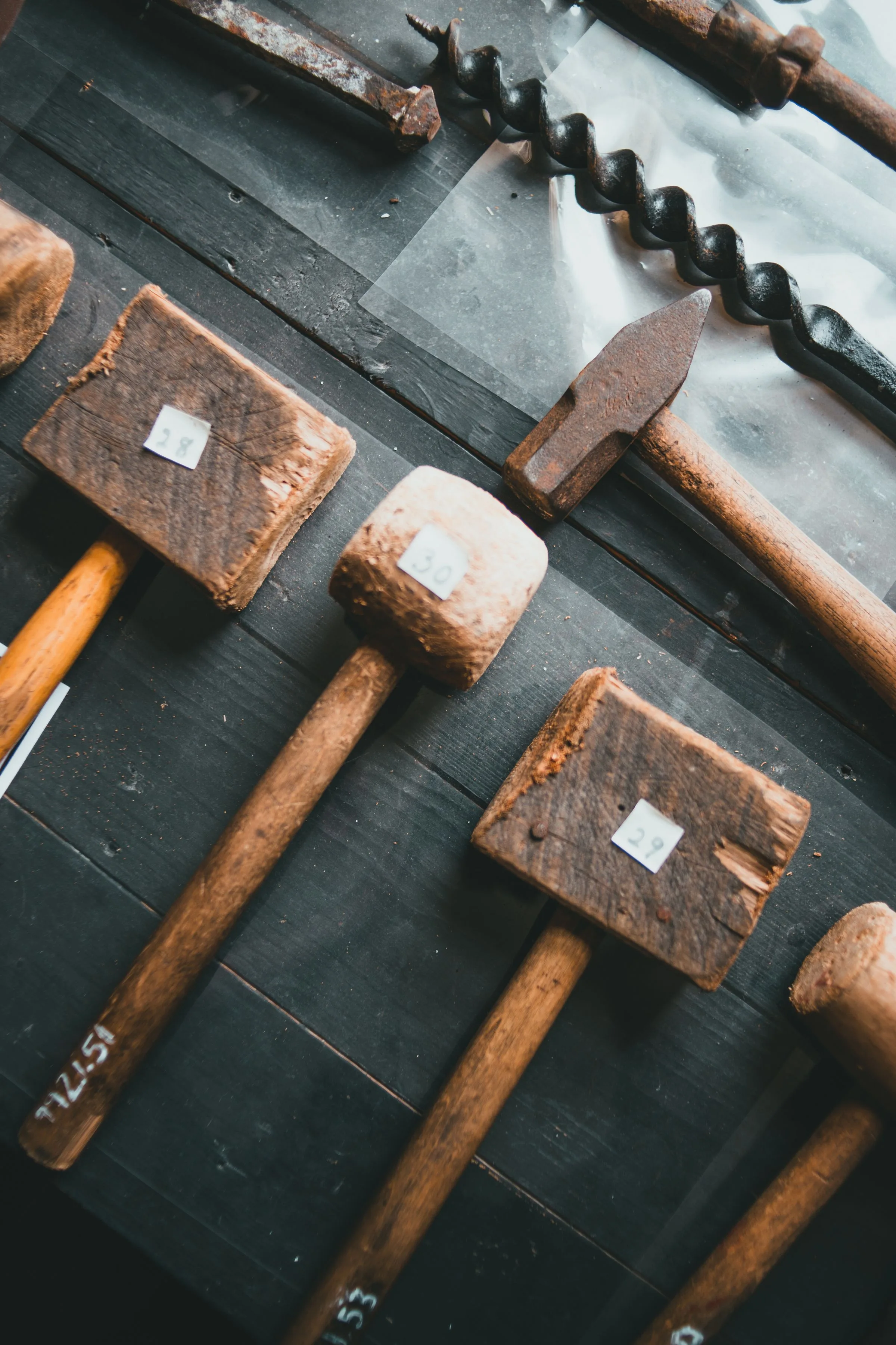 Wooden and iron carpentry tools arranged on a workbench